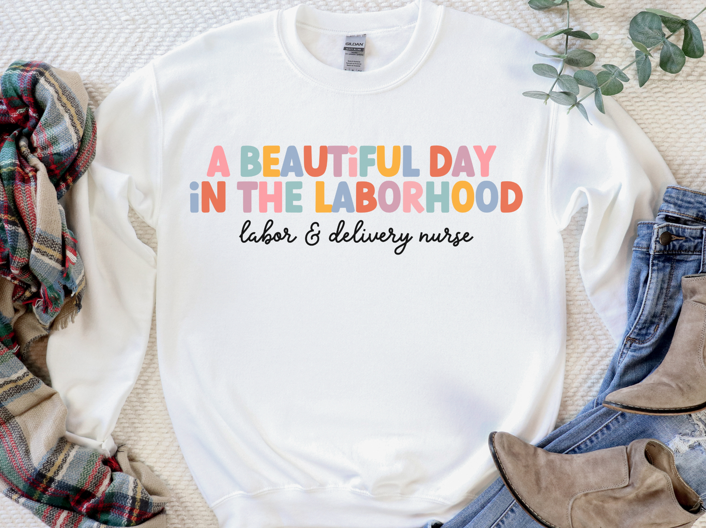 white "a beautiful day in the laborhood" labor and delivery nurse sweatshirt