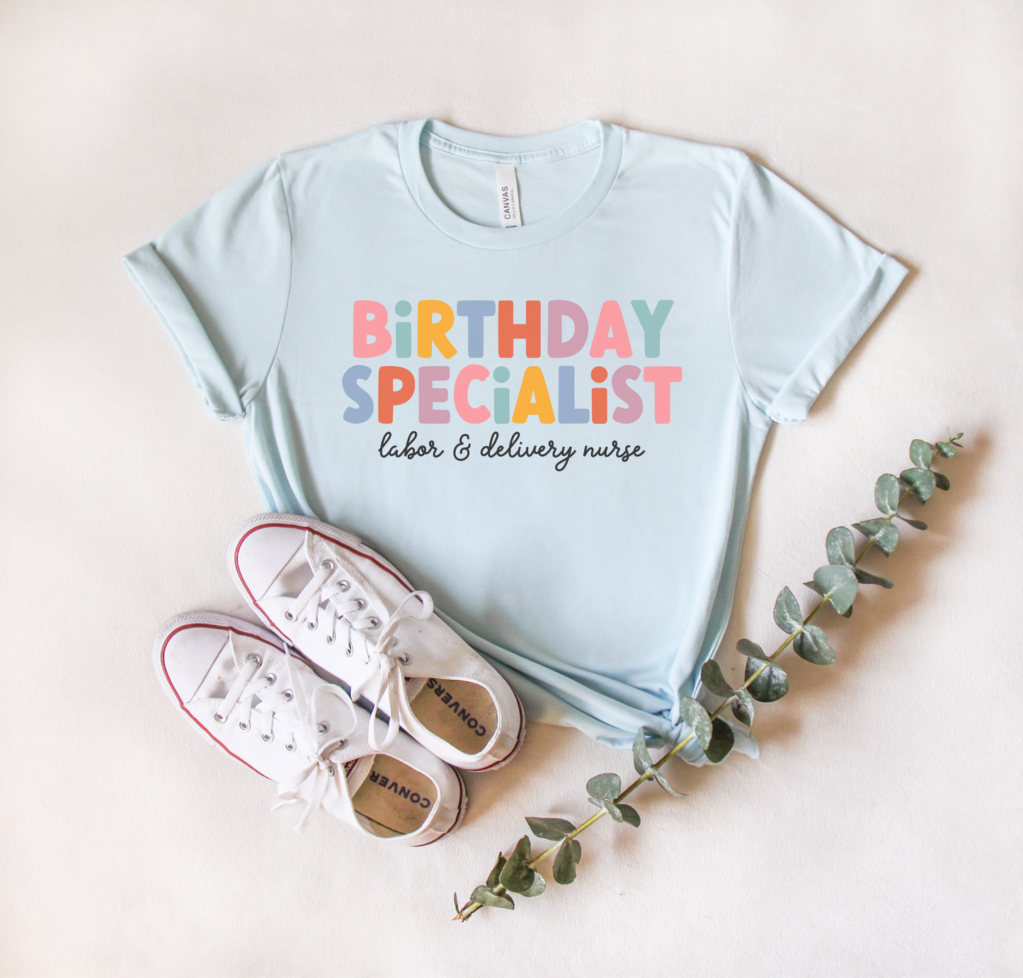 light blue "birthday specialist" labor and delivery nurse t-shirt