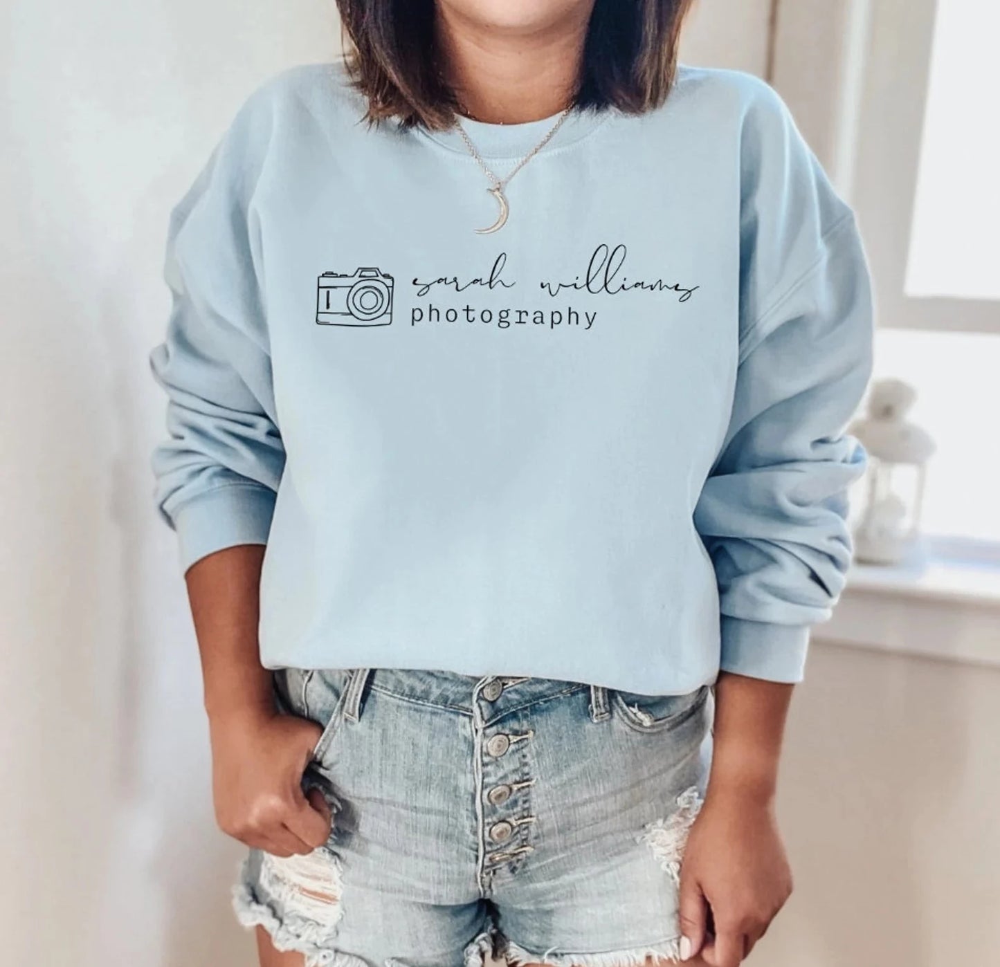 custom photographer sweatshirt with camera icon in light blue