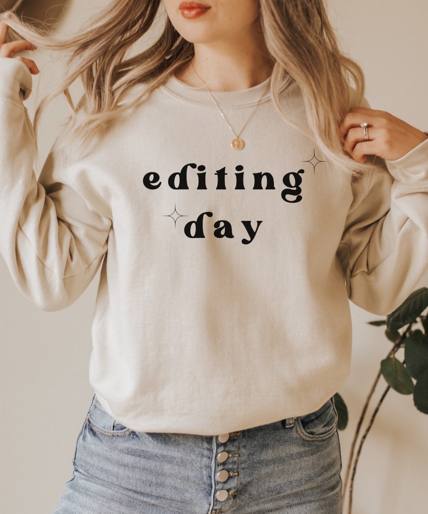 tan "editing day" sweatshirt with retro text