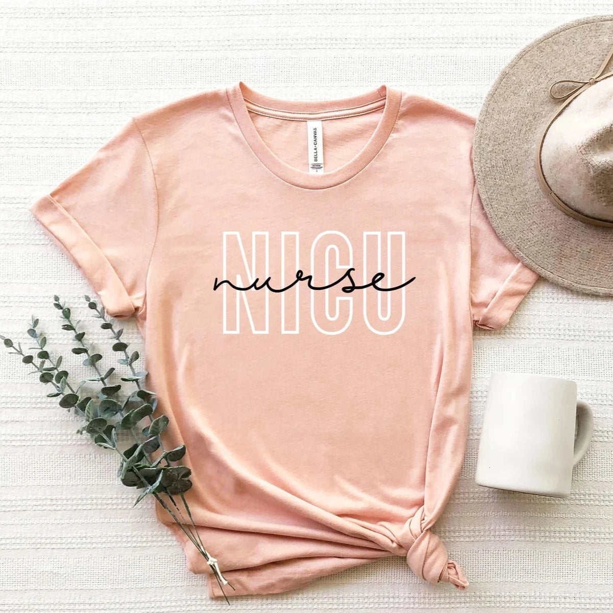 heather peach NICU nurse t-shirt with block and cursive text