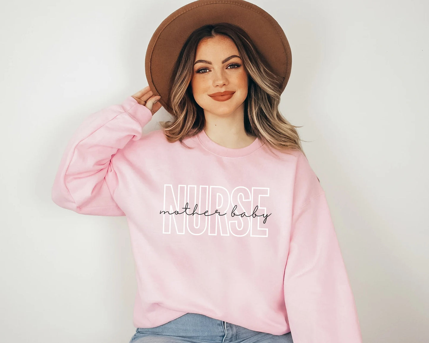 light pink mother baby nurse sweatshirt with block and cursive text