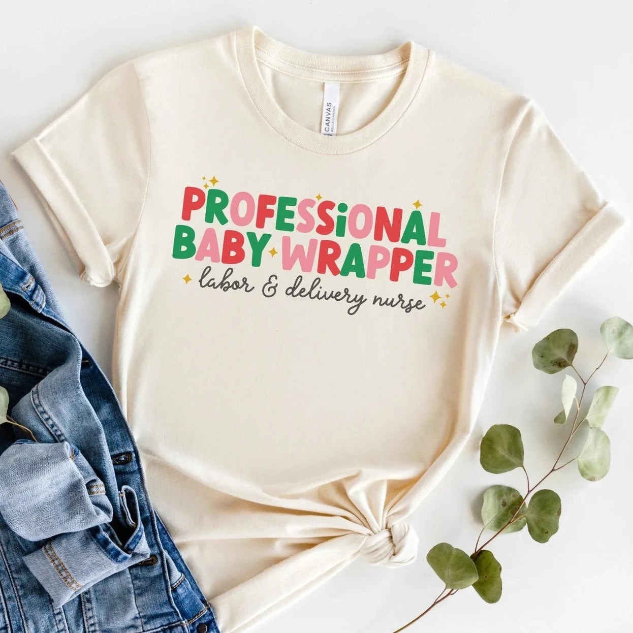 tan "professional baby wrapper" t-shirt with christmas colored text