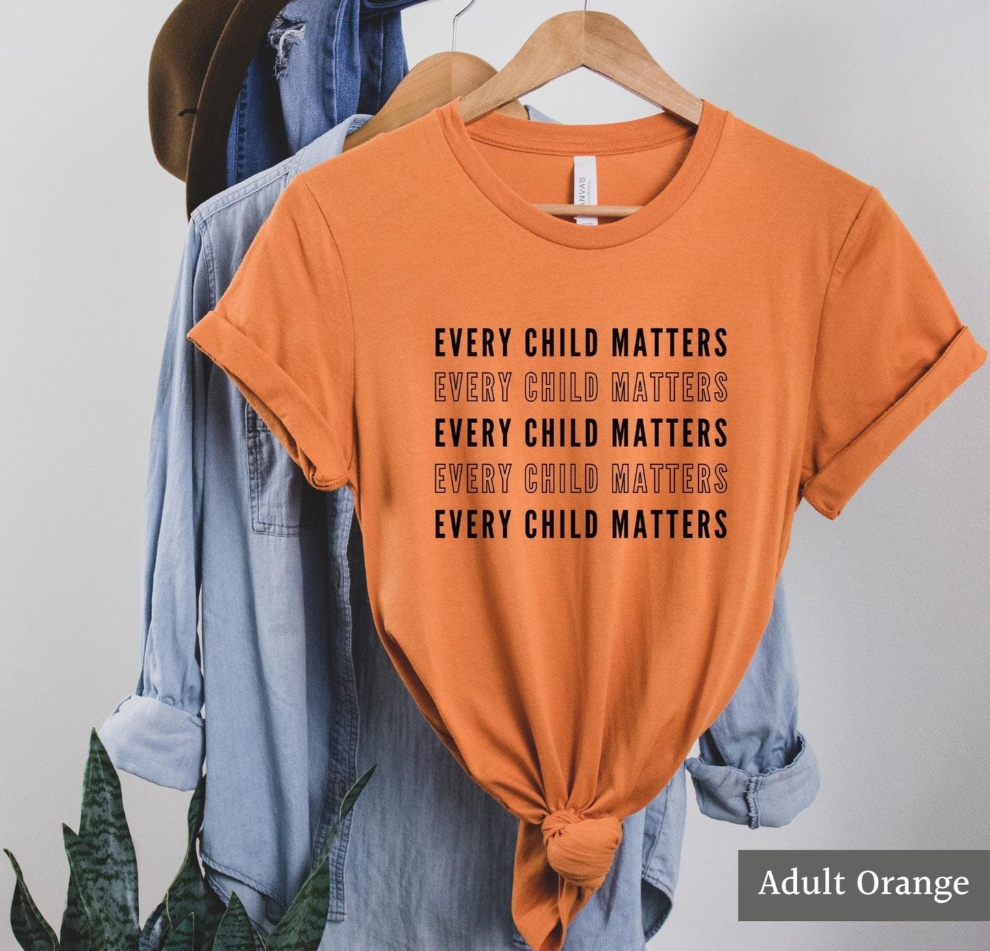 Every child matters shirt with repeating black text