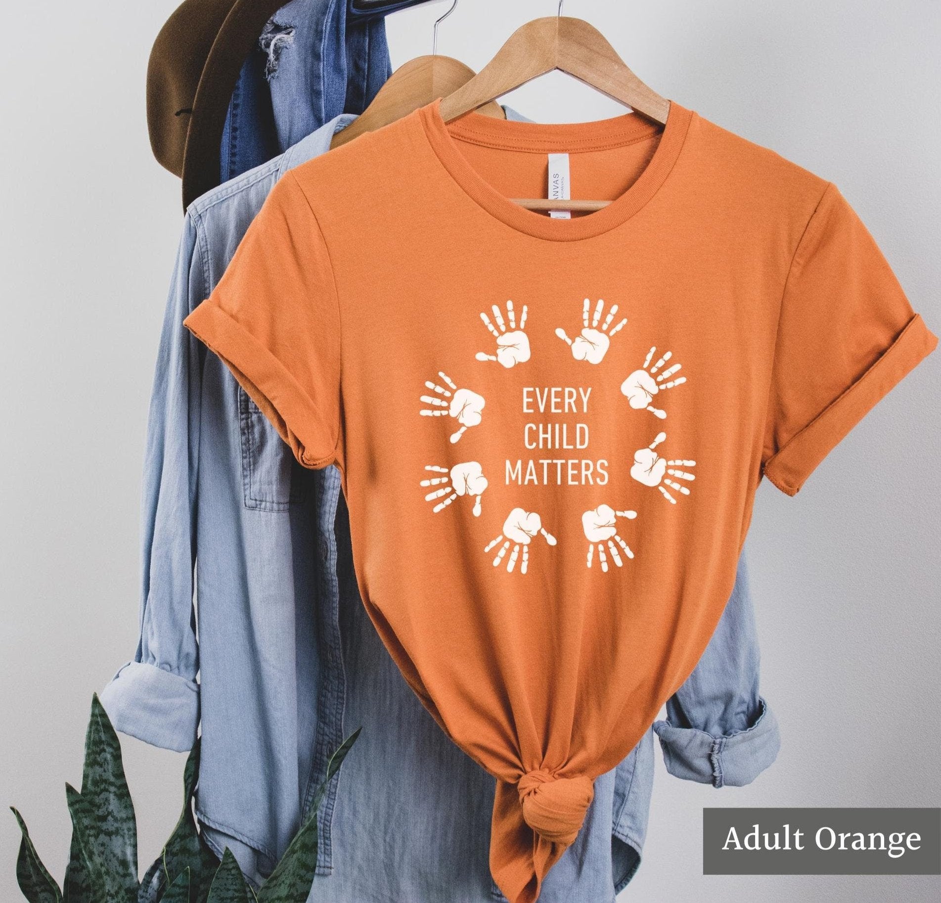 Every child matters shirt with white handprints