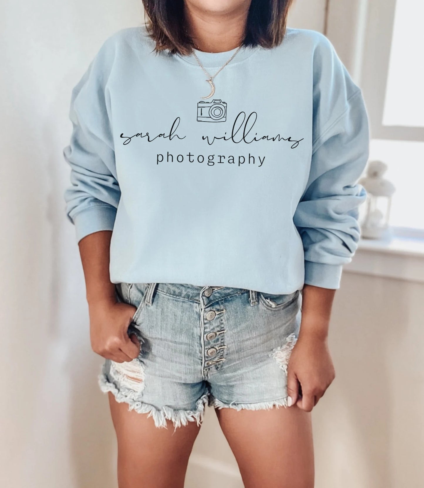 custom photographer sweatshirt with camera icon in light blue