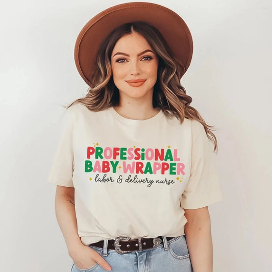tan "professional baby wrapper" t-shirt with christmas colored text