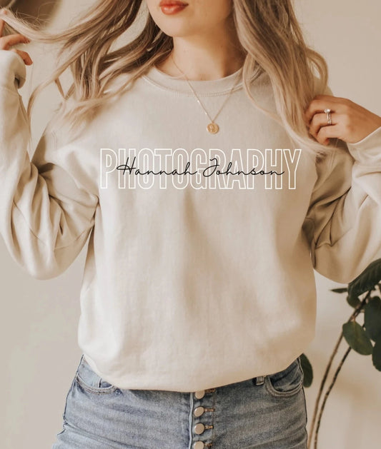 tan colored custom photographer sweatshirt with block and cursive text