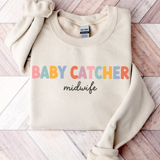tan "baby catcher" midwife sweatshirt with colorful letters