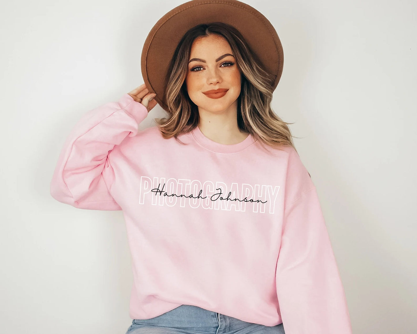 light pink custom photographer sweatshirt with block and cursive text